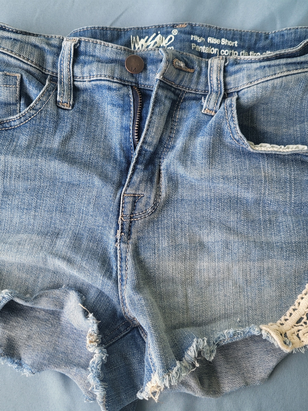 Women’s High-Rise Distressed Denim Shorts in Light Blue